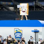 The Pop-Tarts bowl mascot holds up a sign.