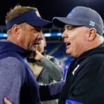 Hugh Freeze and Mark Stoops meet after a game.