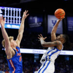 Otega Oweh shoots over Thomas Haugh.