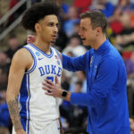 Duke's Tyrese Proctor and Jon Scheyer have a talk on the court during the NCAA Tournament.