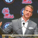 Lane Kiffin speaks at a press conference.
